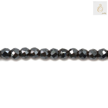 Hematite faceted round beads 2mm diameter with metallic luster on white background