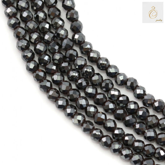 Close-up view of hematite faceted round beads 2mm showing detailed faceted surface and hole