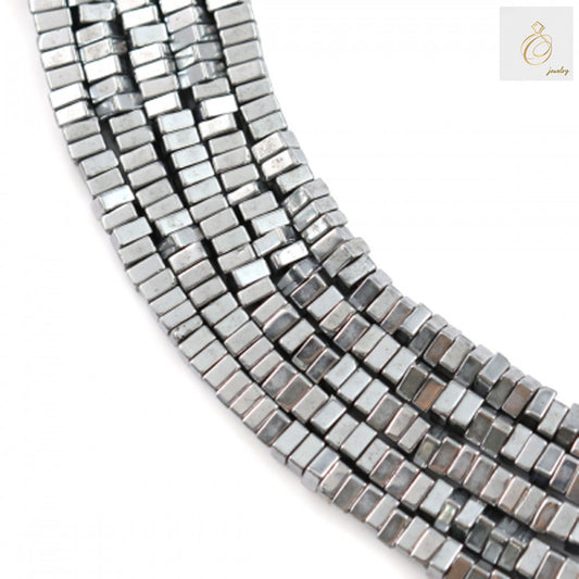 Close-up view of hematite silver square beads 1x2mm with 0.8mm holes, displaying lustrous metallic surface