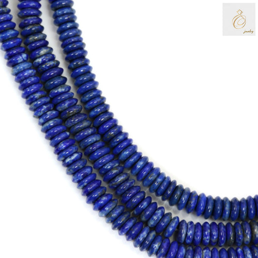 Natural Lapis Lazuli heishi beads 2x6mm blue gemstone strand for jewelry making"
"Blue Lapis Lazuli beads with golden pyrite flecks arranged on white background