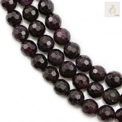 Natural garnet beads strand, 6mm faceted round gemstones, deep red color"
"Close-up of natural garnet beads showing faceted cut and rich red color