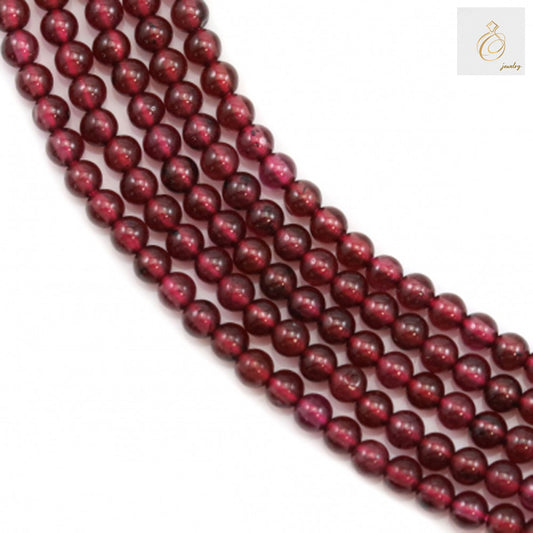Natural garnet beads strand, 2mm round red gemstone beads for jewelry making"
"Close-up of natural garnet beads showing deep red color and consistent round shape