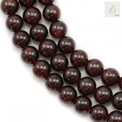 Natural garnet beads strand, 6mm round red gemstone beads for jewelry making"
"Close-up of natural garnet beads showing deep red color and smooth finish"
"Hand holding strand of natural 6mm garnet beads, approximately 63 pieces