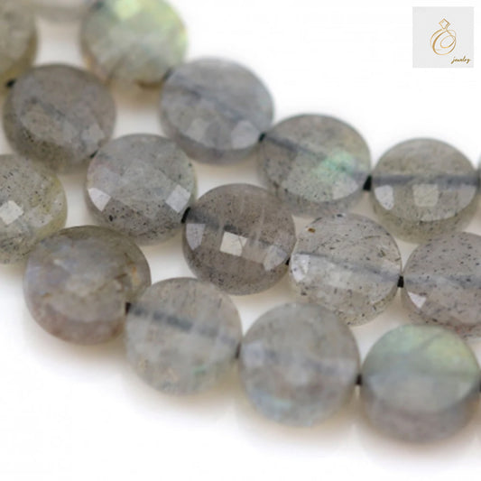 Natural labradorite beads 6mm faceted flat round gemstones showing blue and green flash colors scattered on white background for jewelry making