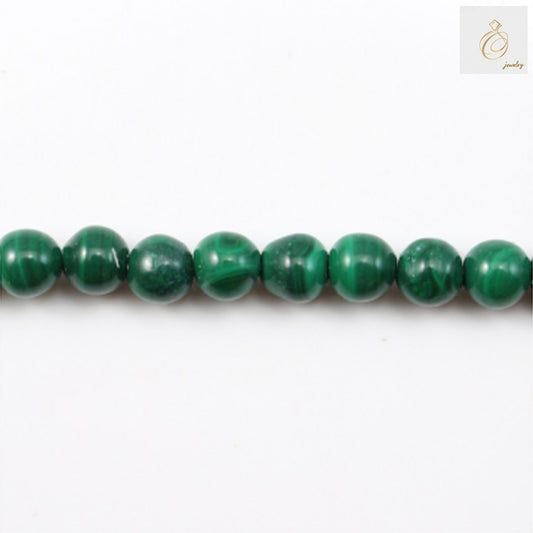 Natural malachite beads strand showing 4mm round green stone beads with distinctive banding patterns"
"Close-up view of natural malachite beads displaying vibrant green color and unique mineral patterns"
"96-piece strand of 4mm natural malachite beads for jewelry making projects