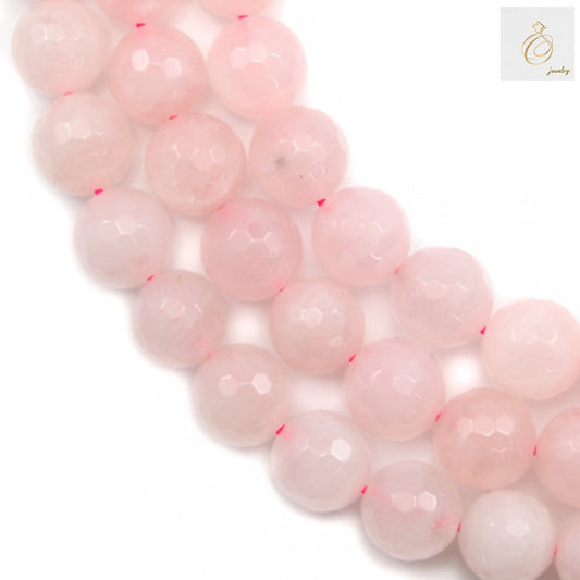 Close-up view of rose quartz beads showcasing faceted surface and translucent pink characteristics