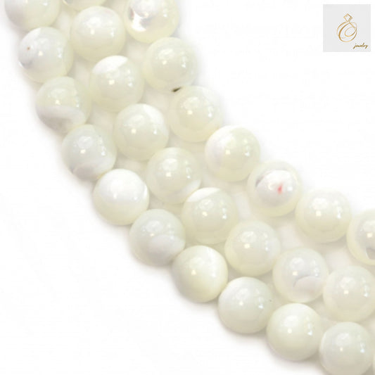 Close-up view of natural white mother-of-pearl shell beads 6mm with 0.8mm holes, approximately 70 beads per strand