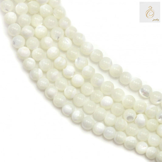 Close-up view of natural white shell mother-of-pearl round beads showing smooth finish and consistent 3mm size, ideal for crafting and jewelry projects
