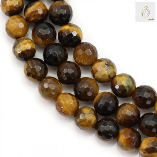 Natural yellow tiger's eye beads strand showing 69 faceted round gemstone beads, 6mm diameter with golden-brown chatoyant bands