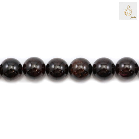 Close-up view of natural garnet beads showing deep red color and smooth round shape
