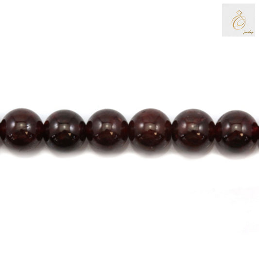 Close-up of natural garnet beads showing deep red color and smooth round shape