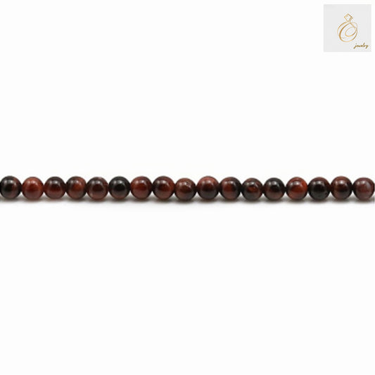 Close-up view of natural red tiger's eye beads showing the beautiful chatoyancy and rich red color variations, 3mm diameter round beads
