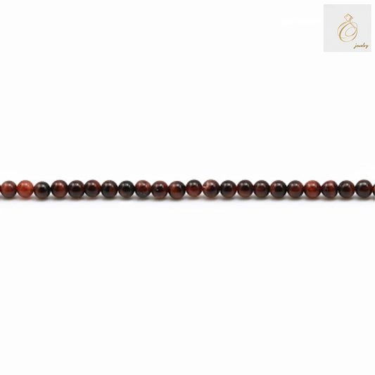 Close-up view of 2mm natural red tiger's eye round beads displaying the characteristic chatoyancy and warm red tones