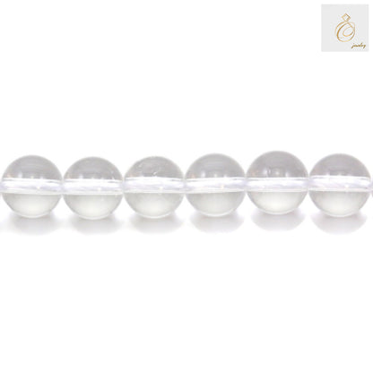 Close-up view of natural rock crystal beads displaying the transparent clarity and round shape of 10mm gemstone beads for DIY jewelry projects
