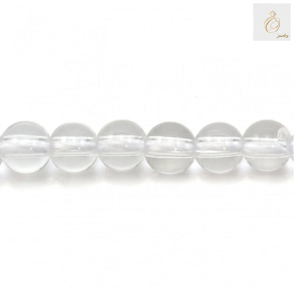 Close-up view of natural rock crystal beads showing clarity and round shape, 4mm diameter perfect for DIY jewelry projects
