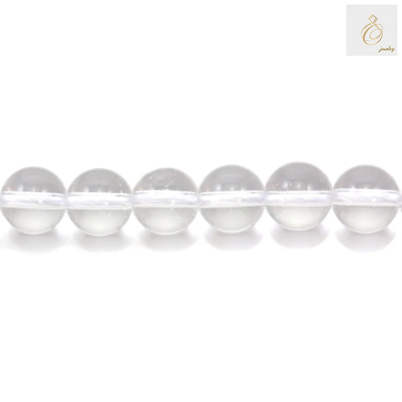 Close-up view of natural rock crystal beads showing clarity and round shape, 6mm diameter jewelry making supplies