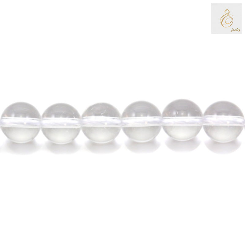 Close-up view of natural rock crystal beads showing clarity and round shape, 8mm diameter gemstone beads for jewelry making