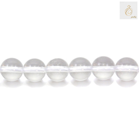 Close-up view of natural rock crystal beads showing clarity and round shape, 8mm diameter gemstone beads for jewelry making