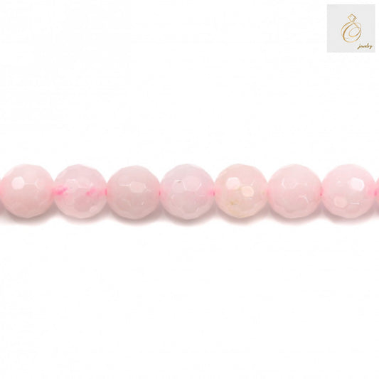 Close-up view of natural rose quartz beads showing faceted surface and pink color