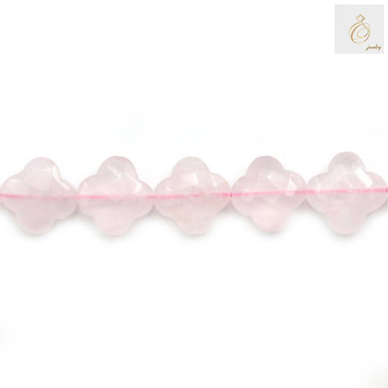 Close-up view of natural rose quartz clover shaped beads showing texture and color