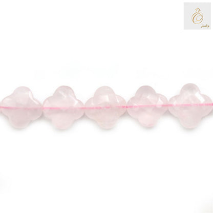 Close-up view of natural rose quartz clover shaped beads showing texture and color
