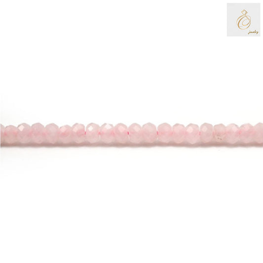Close-up view of natural rose quartz beads strand displaying faceted surface and uniform size