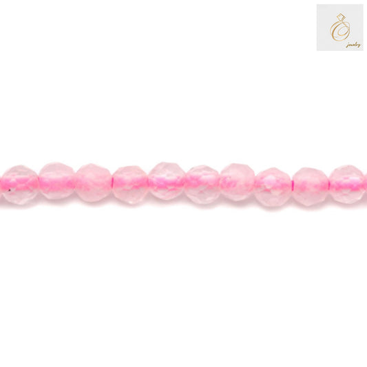 Close-up view of natural rose quartz beads displaying the faceted surface and consistent 2mm diameter