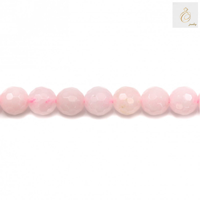 Close-up view of natural rose quartz beads showing faceted round cut and pink translucent color, 8mm diameter