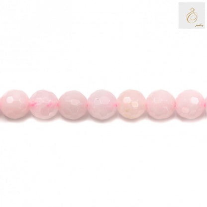 Close-up view of natural rose quartz beads showing faceted round cut and pink translucent color, 8mm diameter