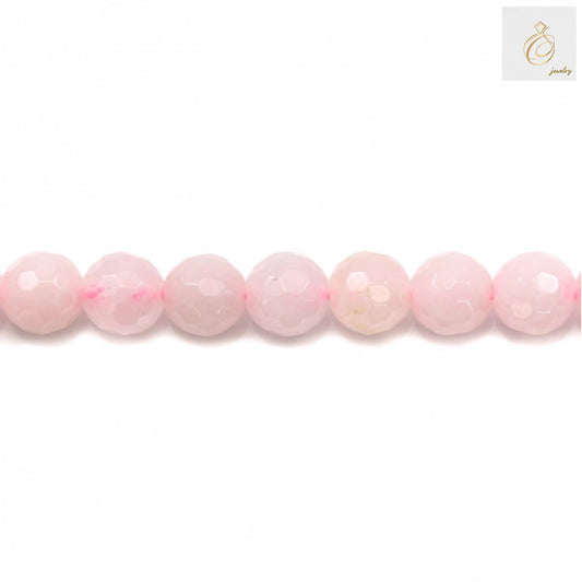Close-up view of natural rose quartz beads showing faceted round cut and pink translucent color, 8mm diameter