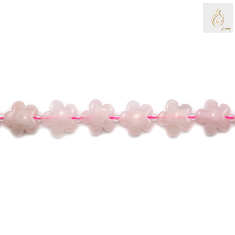 Close-up view of natural rose quartz flower beads displaying translucent pink color and smooth finish