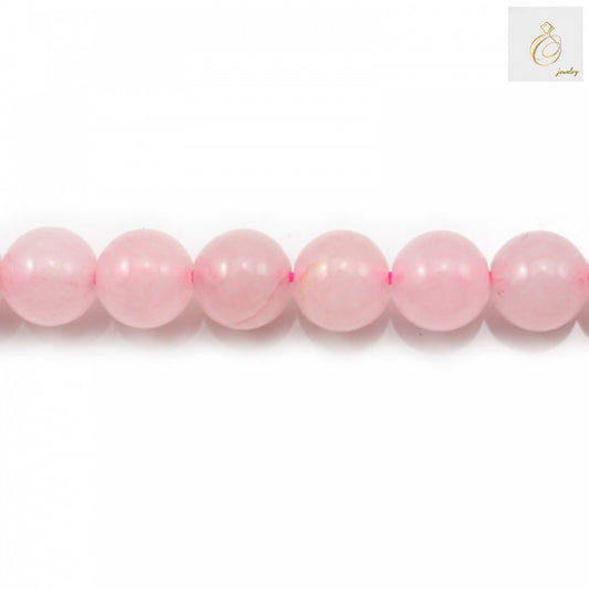 Close-up view of natural rose quartz beads showing pink gemstone color and smooth round finish, 10mm size
