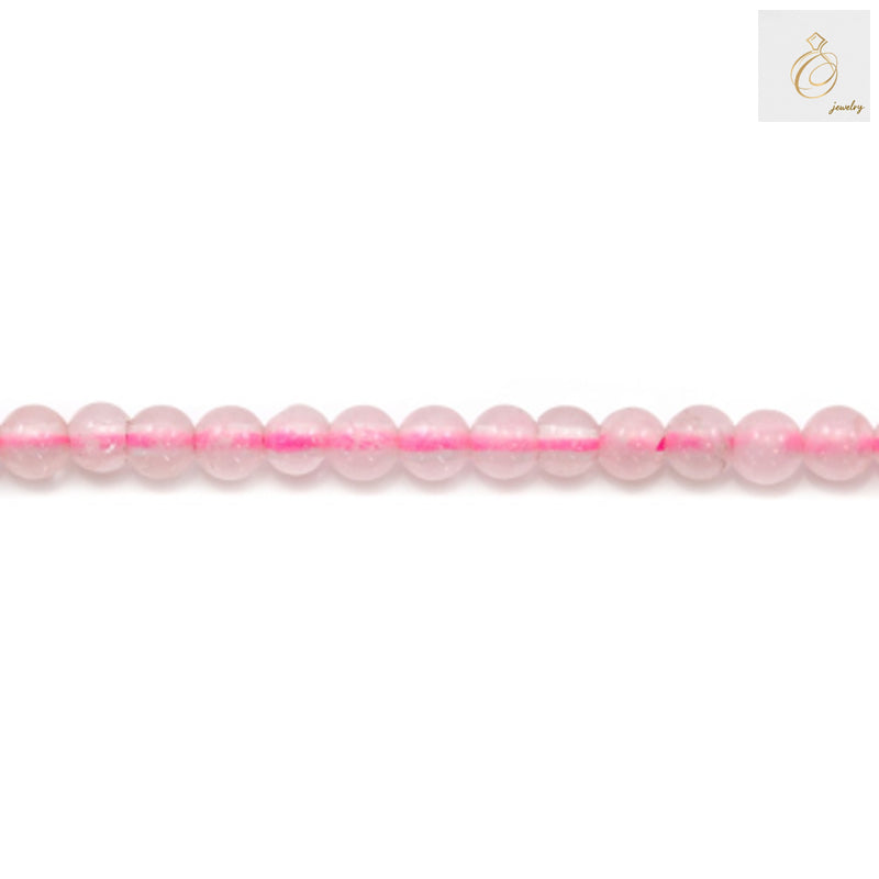 Close-up view of natural rose quartz beads showing pink color and round shape, 2mm diameter
