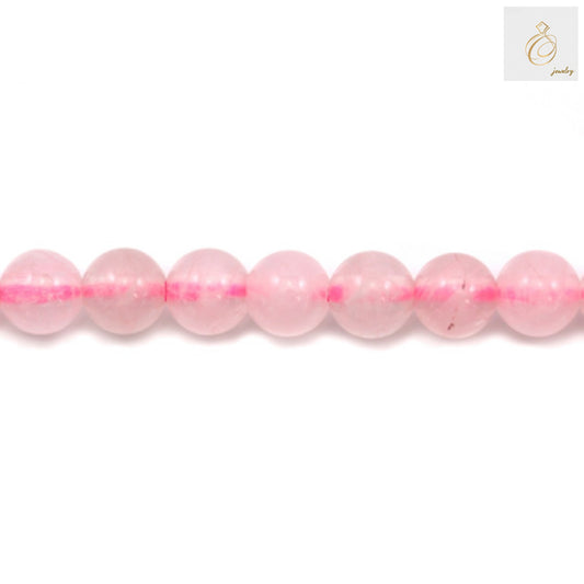 Close-up view of natural rose quartz beads, 4mm round gemstones in soft pink color, perfect for DIY jewelry and craft projects