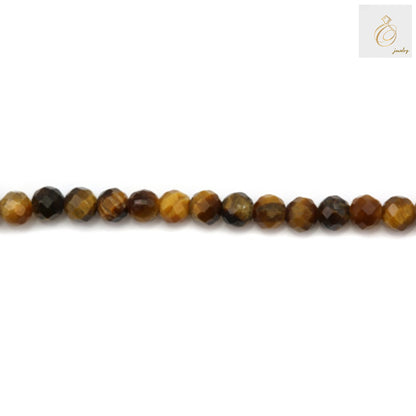 Close-up view of natural tiger's eye gemstone beads showing faceted surface and distinctive golden striped pattern