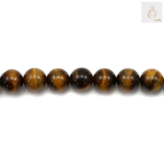 Close-up view of natural yellow tiger's eye round beads displaying characteristic golden striped patterns and smooth finish