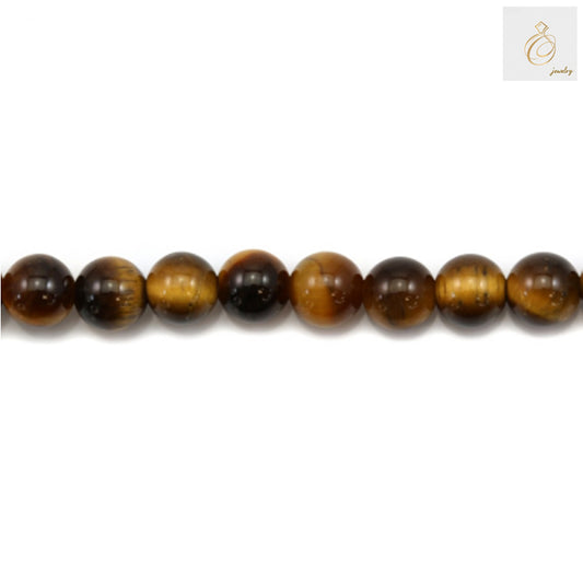 Close-up detail of natural yellow tiger's eye beads showing smooth round shape and distinctive chatoyant tiger eye patterns, perfect for jewelry making and crafts