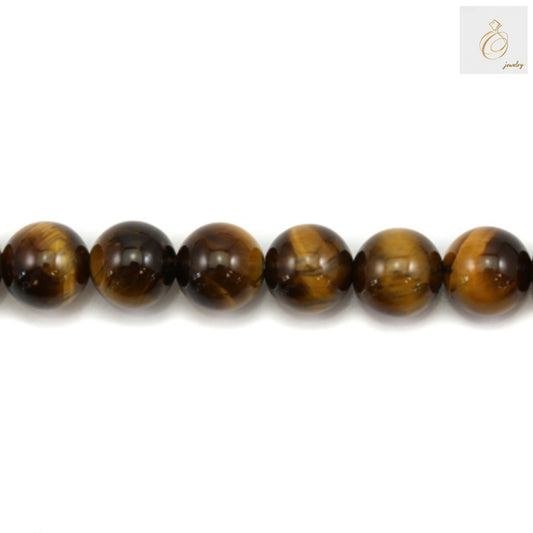 Close-up of natural yellow tiger's eye beads showing smooth polished surface and distinctive golden striped patterns