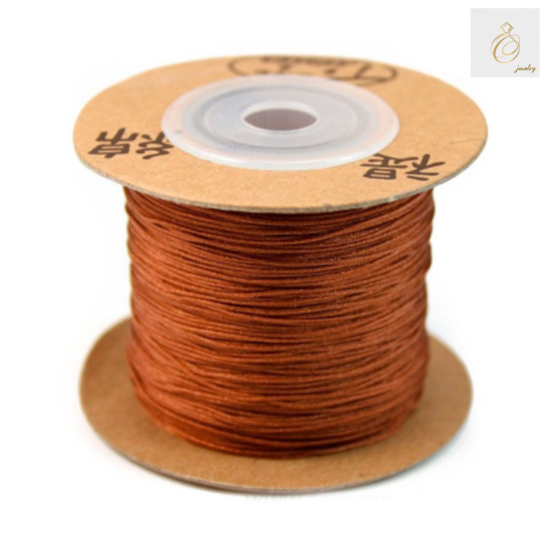 Caramel colored polyester jewelry thread spool 0.5mm diameter"
"Premium polyester thread for jewelry making in caramel color"
"180 meter spool of 0.5mm caramel polyester crafting thread