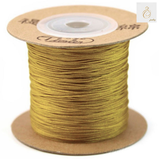 Premium golden polyester jewelry thread 0.5mm diameter on spool"
"Golden polyester thread for jewelry making and beading projects"
"High-quality 0.5mm golden thread 180m length for crafting