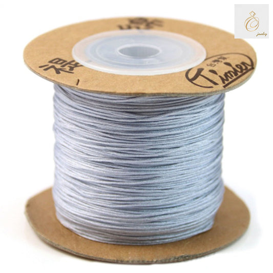Grey polyester jewelry thread 0.5mm diameter on white background"
"Professional crafting thread spool for jewelry making"
"Close-up of fine grey polyester thread texture