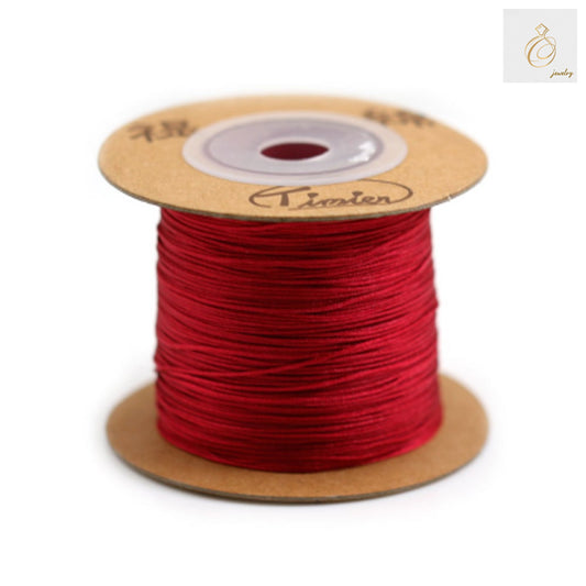 Red polyester jewelry thread spool 0.5mm diameter for beading and crafts"
"Premium red beading thread 180 meter spool for jewelry making"
"Close-up of vibrant red polyester thread on white spool"
"Professional jewelry making thread in bright red color