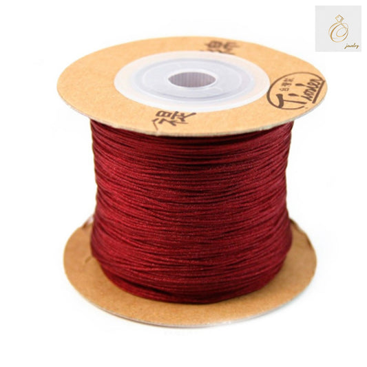 Red polyester jewelry thread 0.5mm diameter on 180m spool"
"Premium red craft thread for jewelry making and beading"
"Close-up of vibrant red polyester thread for jewelry crafting