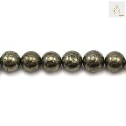 Close-up view of pyrite beads displaying the characteristic golden metallic shine and smooth polished surface finish