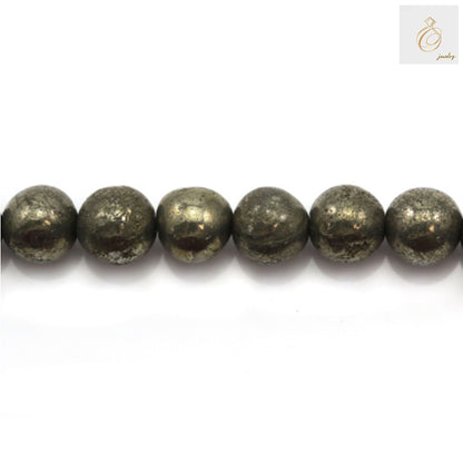 Close-up view of pyrite beads displaying the natural golden metallic shine and consistent 6mm round shape, ideal for crafting bracelets and necklaces