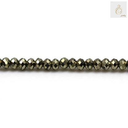 Close-up of pyrite faceted abacus beads showing brilliant metallic luster and precise cut