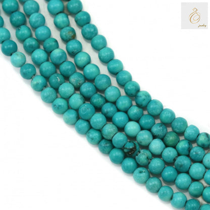 Reconstituted turquoise round beads 2mm diameter on strand, showing blue-green color and natural veining patterns