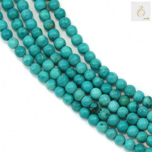 Reconstituted turquoise round beads 2mm diameter on strand, showing blue-green color and natural veining patterns