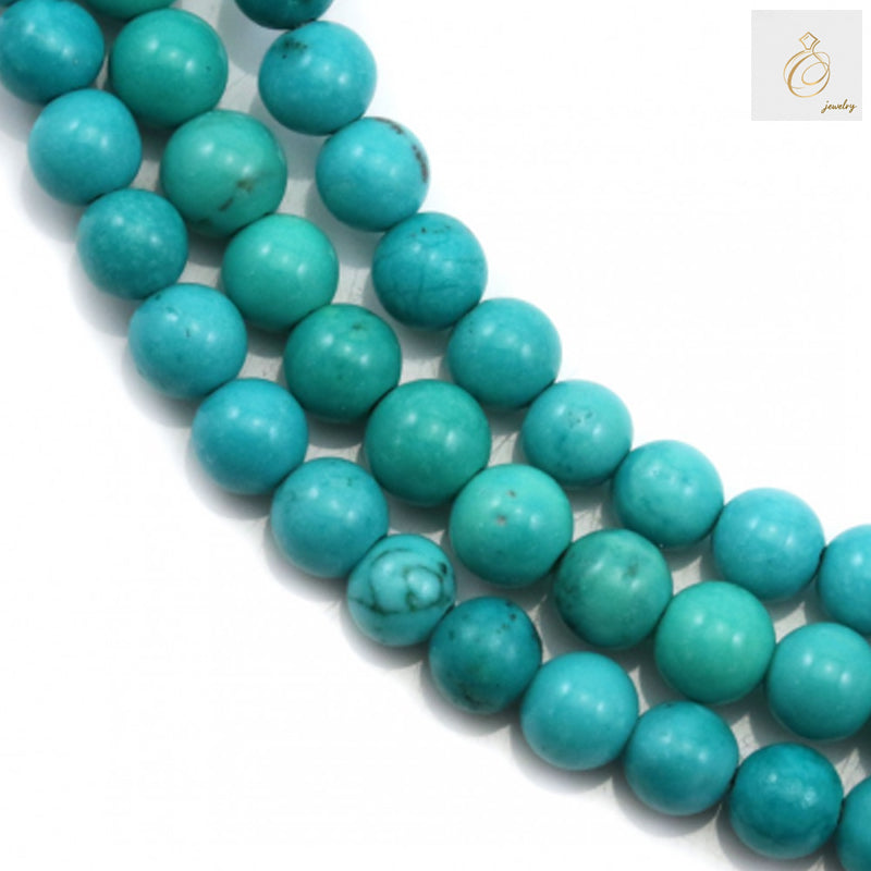 Reconstituted turquoise round beads 6mm on strand - close up view showing natural blue-green color and texture
