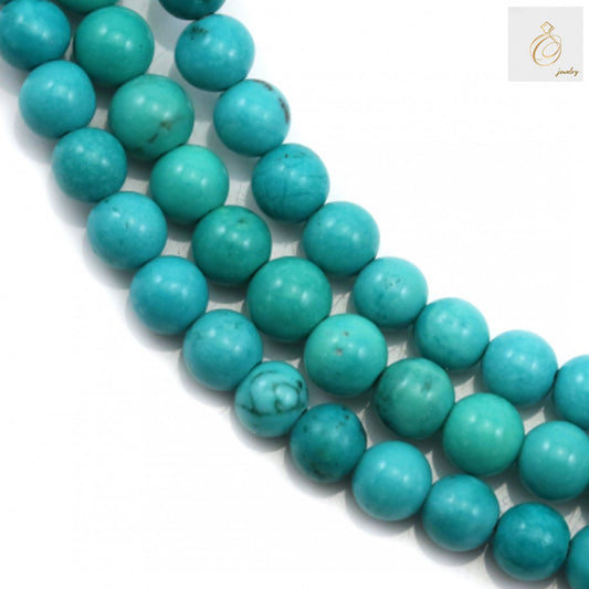 Reconstituted turquoise round beads 6mm on strand - close up view showing natural blue-green color and texture